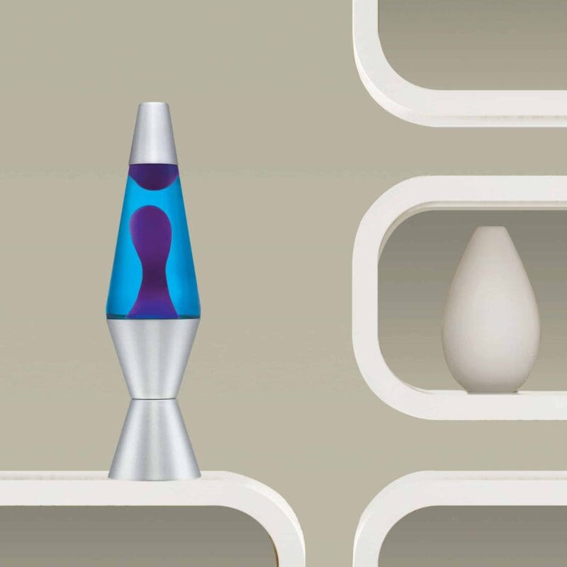 21180401US-LavaLamp-14-5-Purple-and-Blue-Lifestyle2-web 14.5” LAVA® Lamp – Purple/Blue/Silver on a shelf